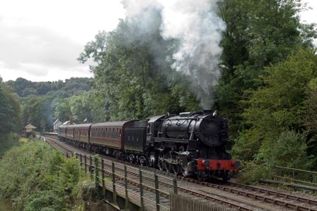 A steam train departs from Consall station